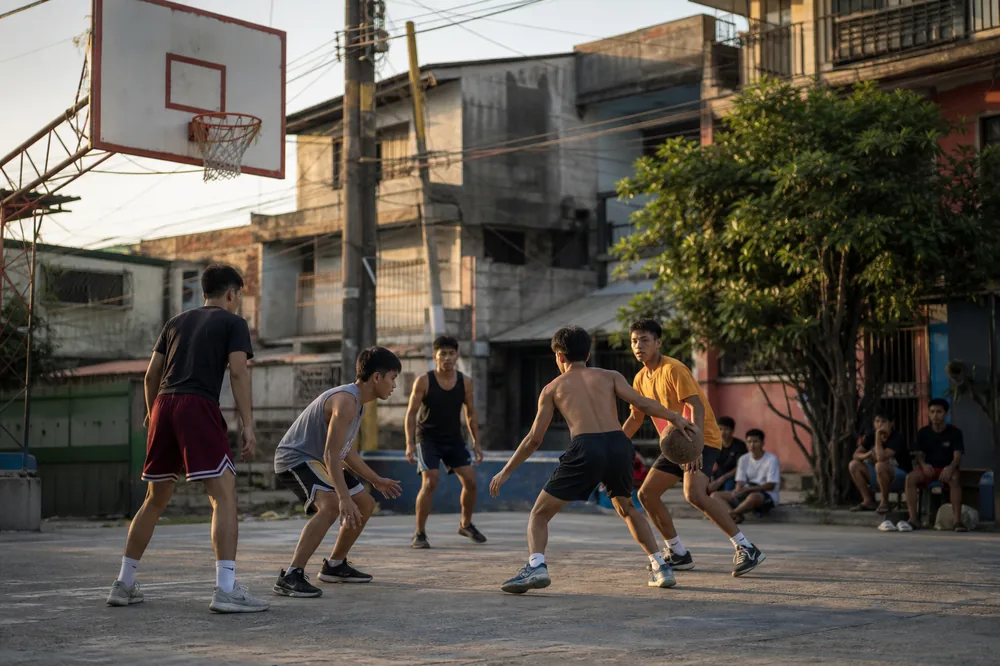 Friends playing neighborhood basketball outdoors